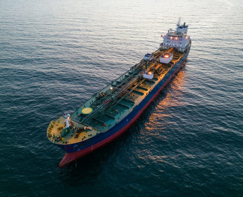 Aerial top view oil ship tanker carrier oil on the sea at sunset